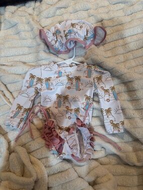 Long Sleeve Pink Trim infant One-Piece Swimsuit with Ruffle Bottom with hat